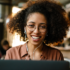 young-african-woman-smiling-while-using-laptop-and-2025-02-16-09-41-05-utc.png